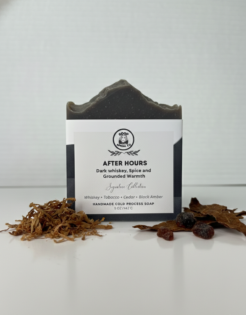 dark grey bar of soap with dried leaves nesting in front