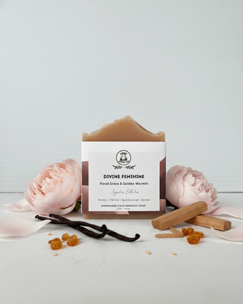 Bar of soap with a vanilla bean and flowers on a white background