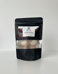 Black packaging of tallow truffles with a visible brand label on a white background