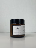 Jar of body butter with a white label on a white background.