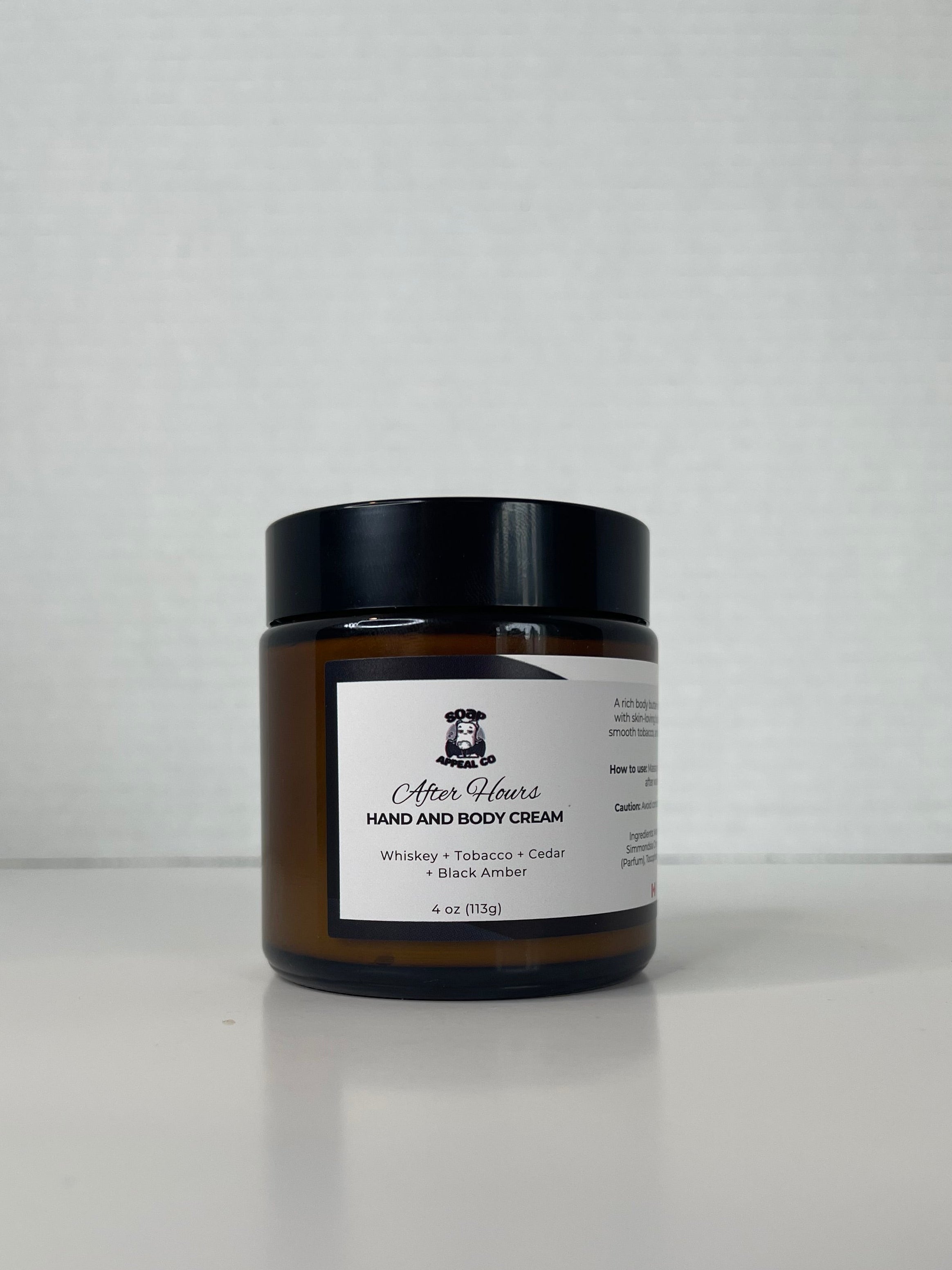 Jar of body butter with a white label on a white background.