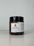 Small jar with a label on a light gray background