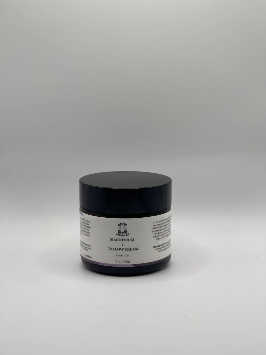 Small jar of tallow magnesium lavender cream on a white background