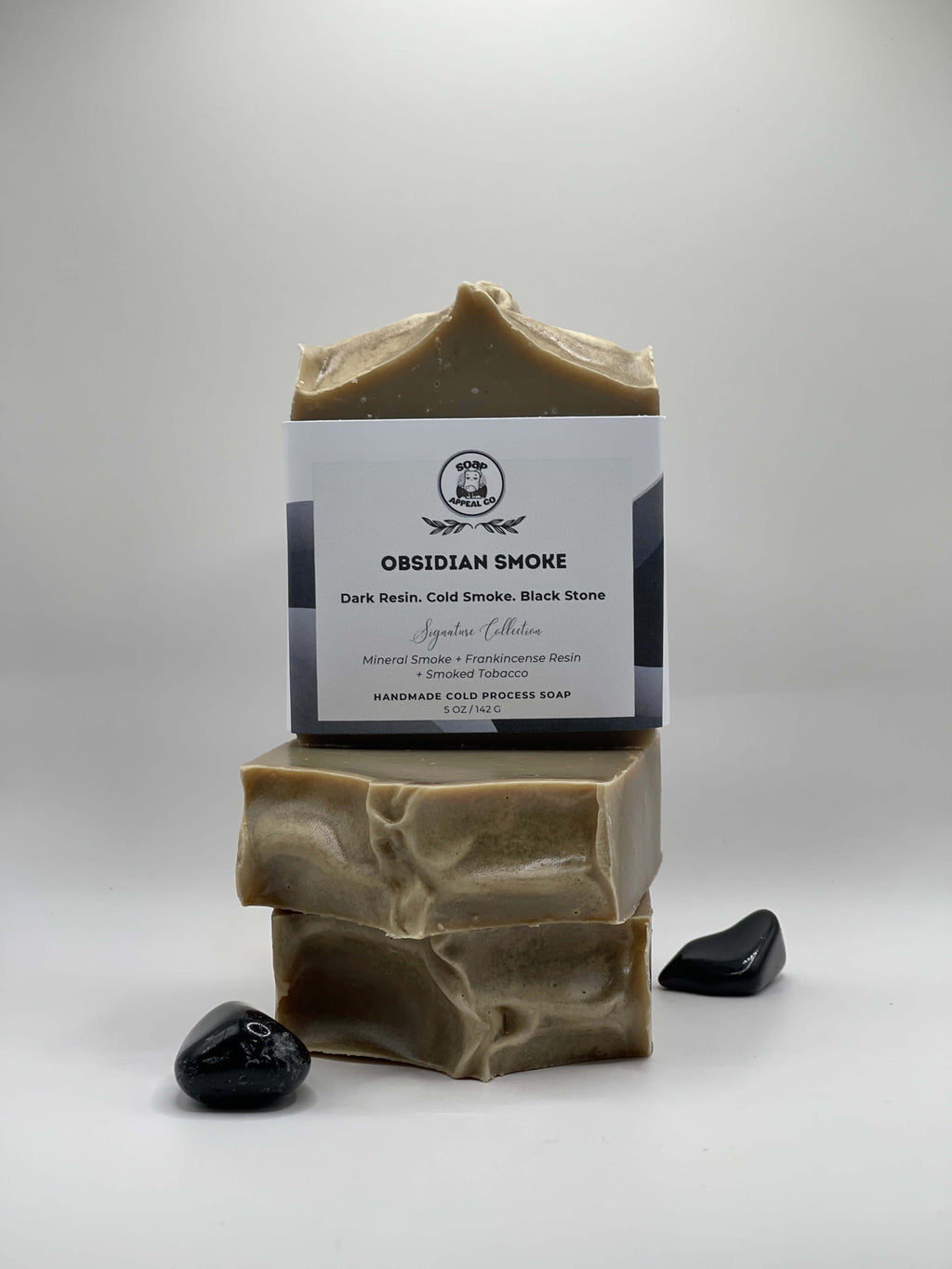 3 bars of grey soap with a label on a white background