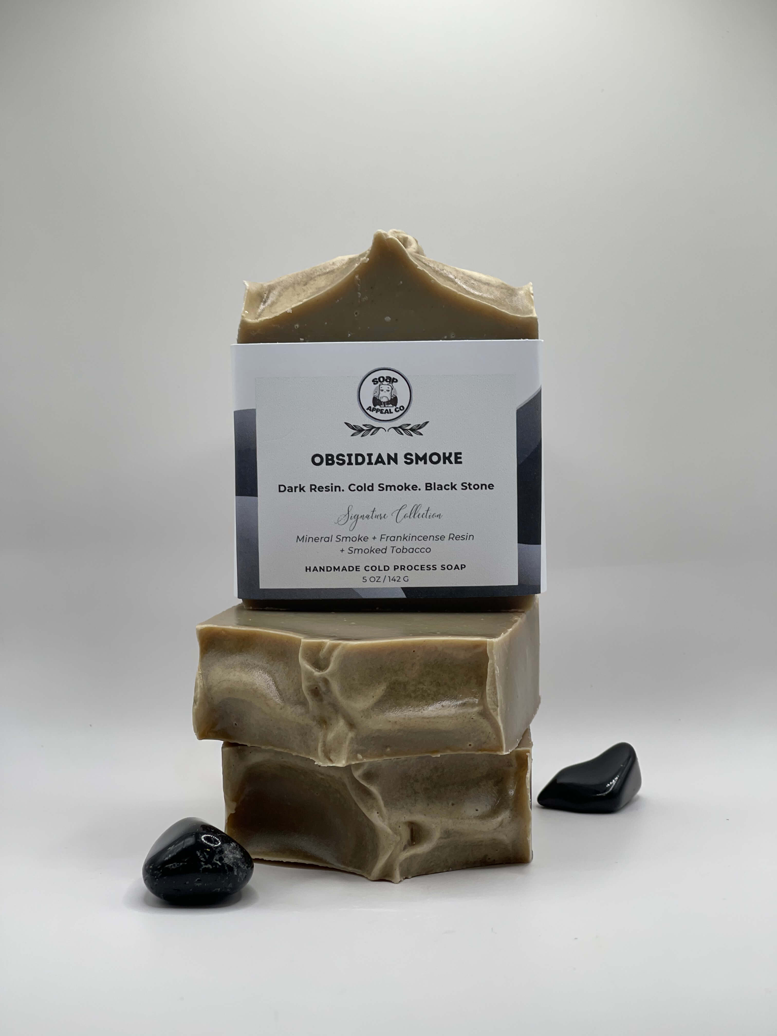 3 bars of grey soap with a label on a white background