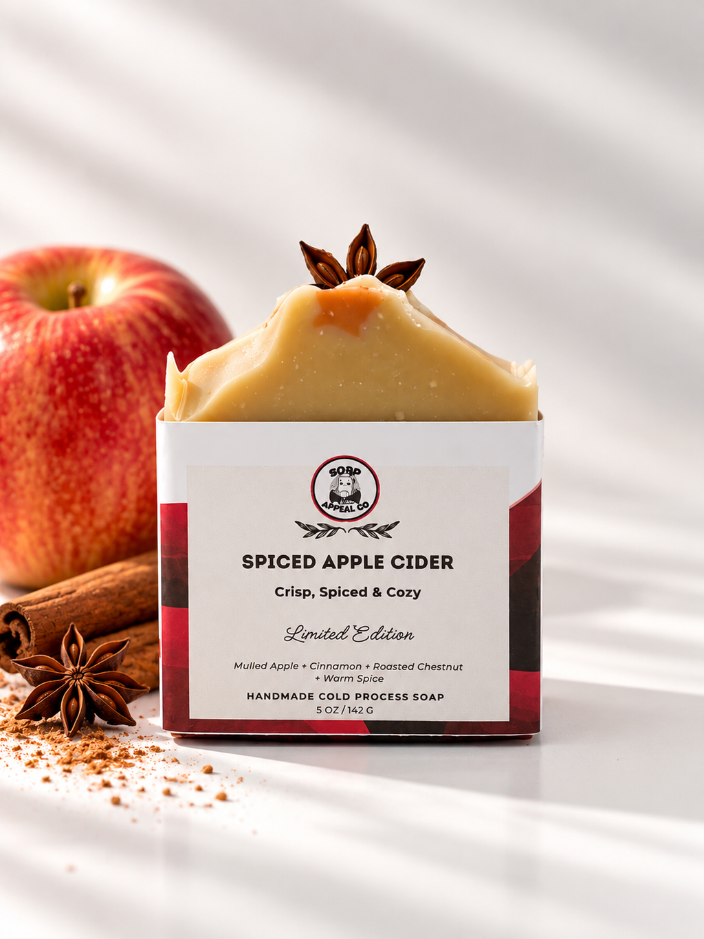 Apple cider soap on a white background with a red apple and cinnamon